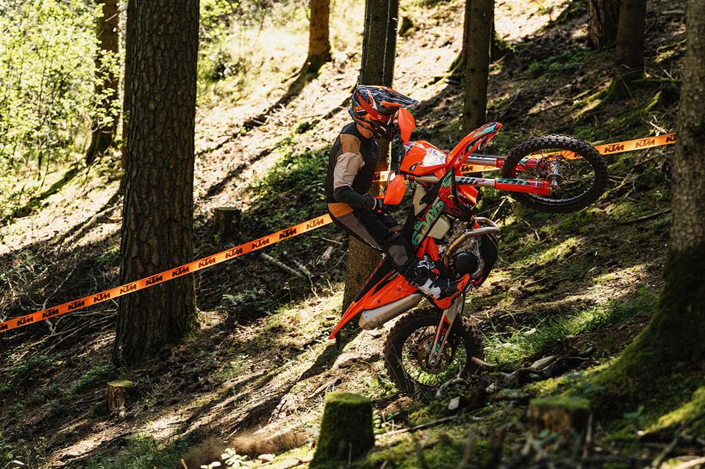2027 KTM EXC 6DAYS riding up a hill